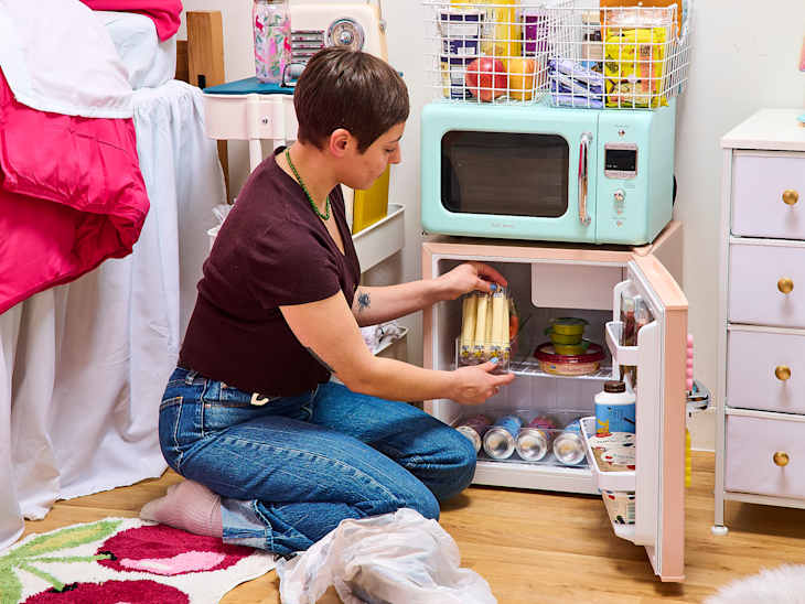 someone cleaning out a fridge