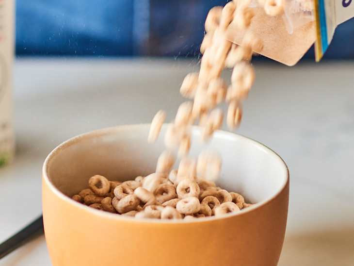 Cereal being poured into bowl.