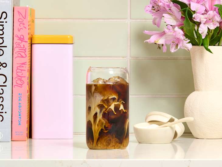 head on shot of iced coffee with milk on a kitchen counter