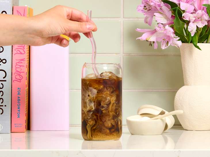 head on shot of iced coffee with milk on a kitchen counter