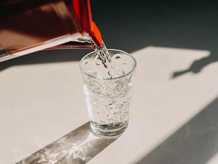 Pitcher pouring water in a glass