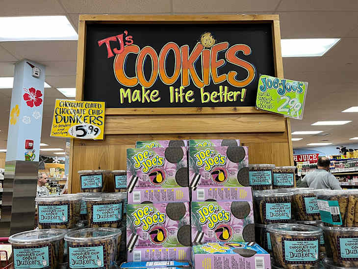 A display of cookies at Trader Joe's. A sign says "TJ's Cookies Make Life Better!".