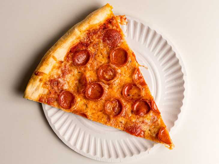 Pepperoni pizza slice on a paper plate