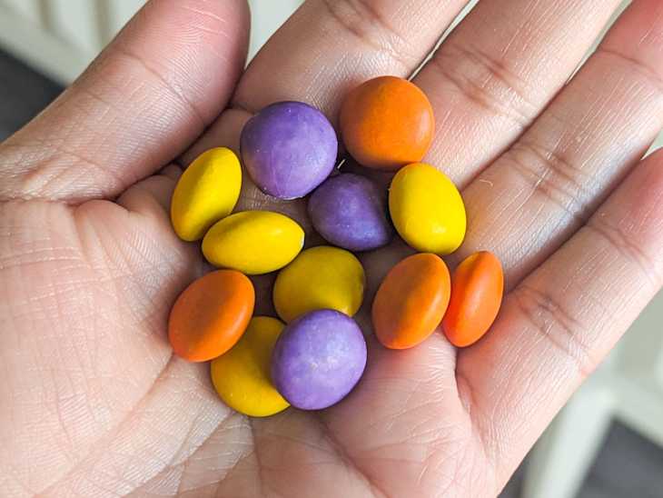Someone with a handful of candy.
