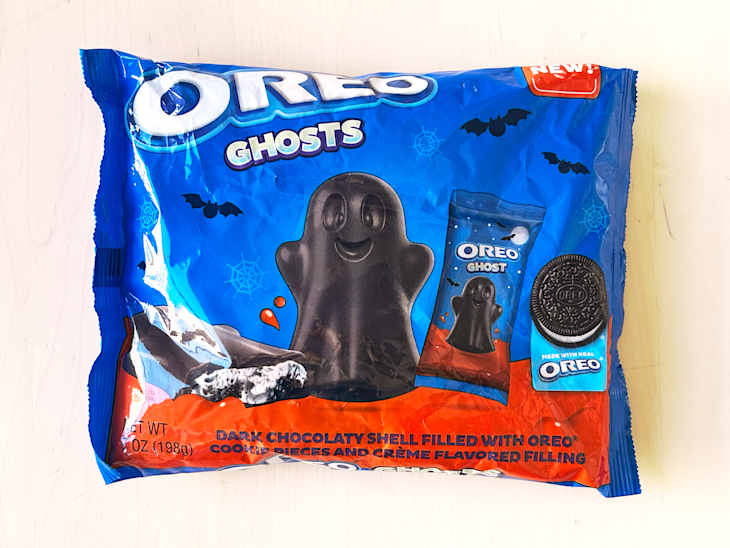 Oreo Ghosts package featuring a dark chocolaty ghost-shaped cookie, with bats and spiderwebs on a blue background.
