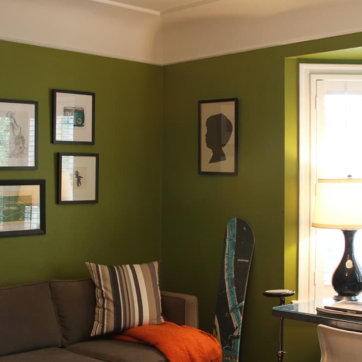 Deep green room with couch and desk