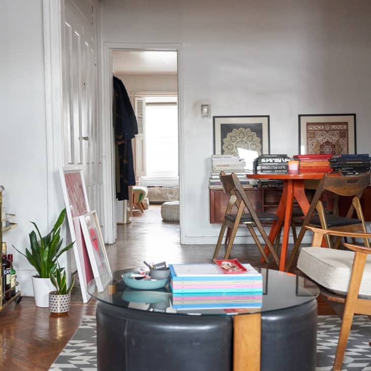 living room with glass coffee table and white chairs