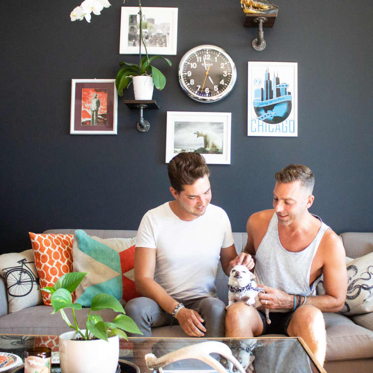 black living room has lots of natural light, orange and teal accents