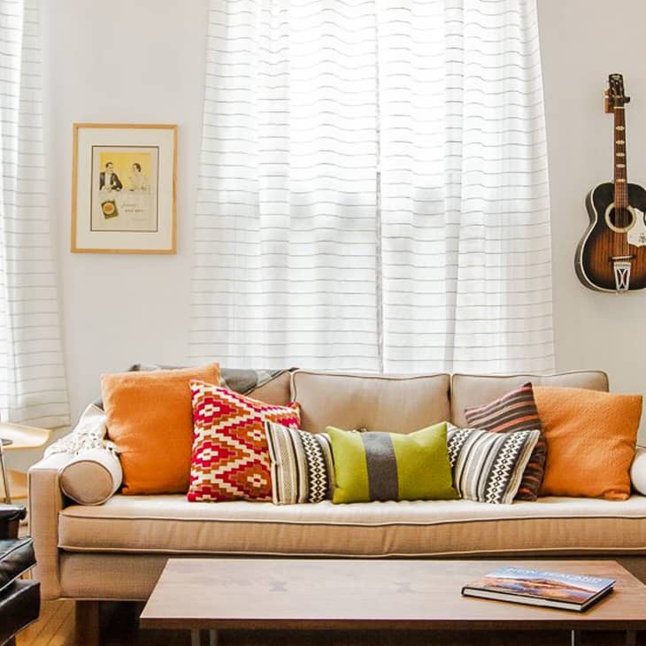 A single coffee table book is on a wooden coffee table
