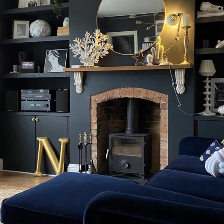 living room features an expansive black wall that disguises an entertainment system