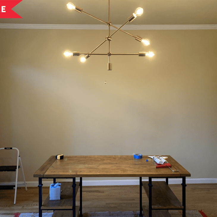 Dining room with wooden table, modern chandelier, step ladder, and tools on table, marked "Before" in red banner.
