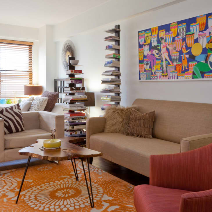 Orange rug in a colorful studio apartment living room