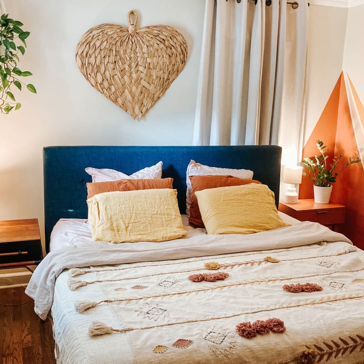 Bedroom with wicker heart above bed