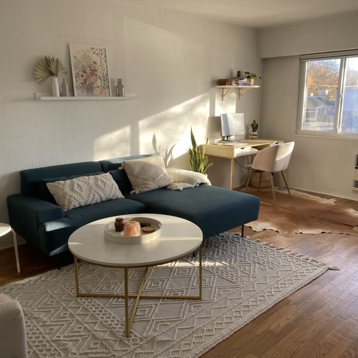 Living room with navy couch and big window