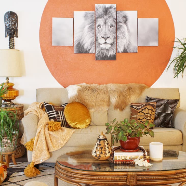 Living room with lion artwork and tan, orange, and green color scheme