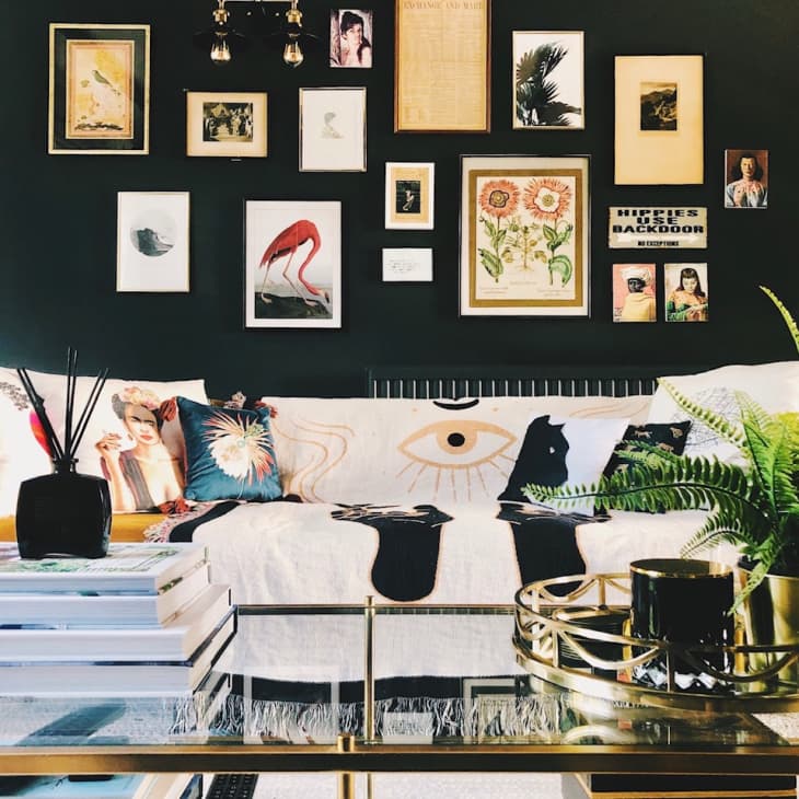 Gold sofa with gallery wall above