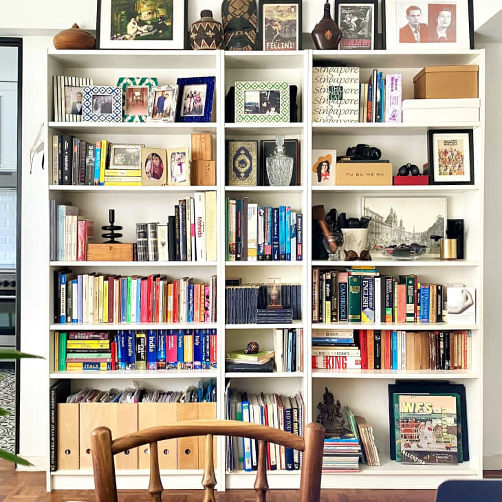 White built-in bookshelf between kitchen and living room