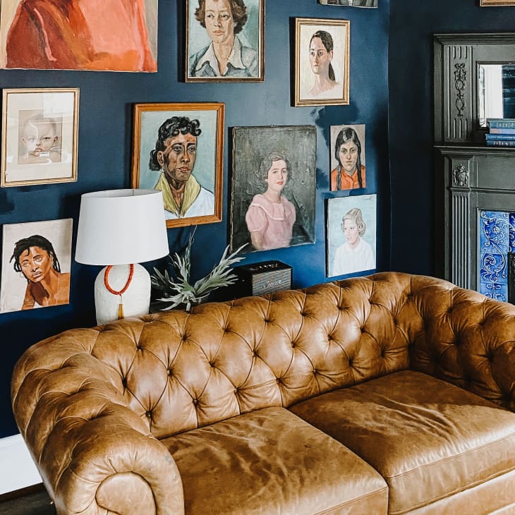 Leather Chesterfield sofa in front of gallery wall