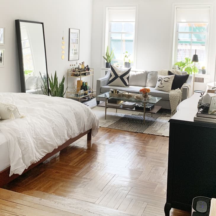 Bright studio apartment with black, white, and neutral color scheme