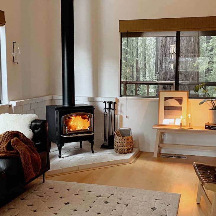 Warm, textured living room with black wood-burning stove in corner