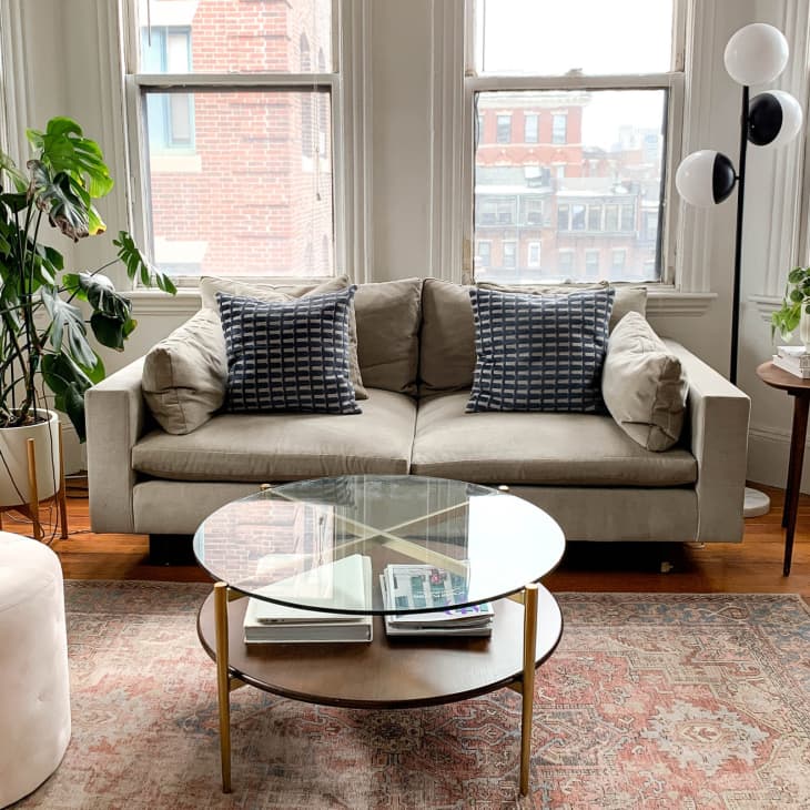 Bright, neutral living room with large windows