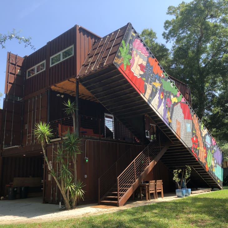 Shipping container house with mural on side