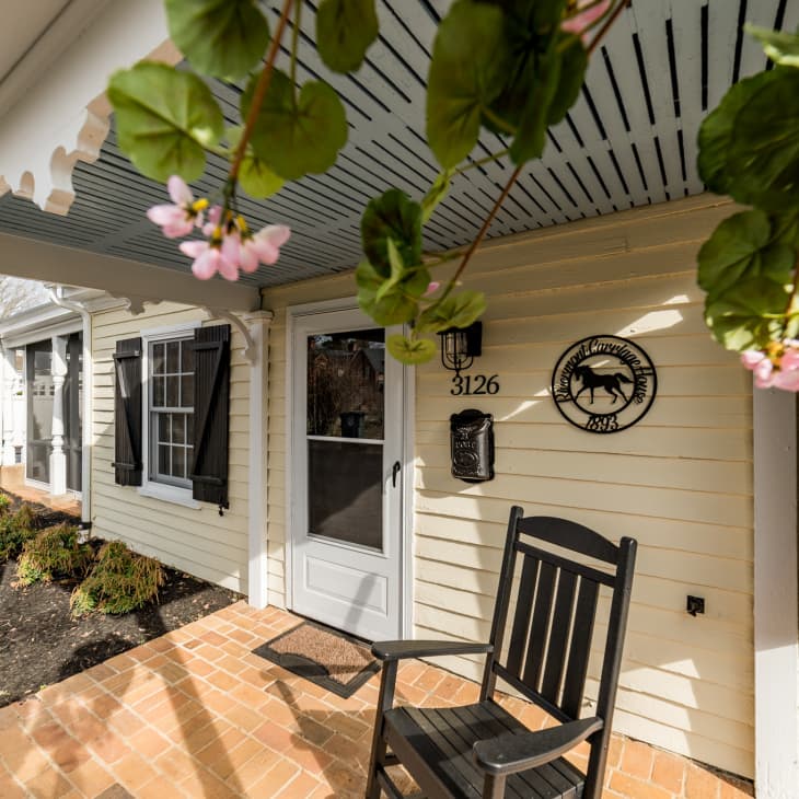 Brick porch with black rocking chair