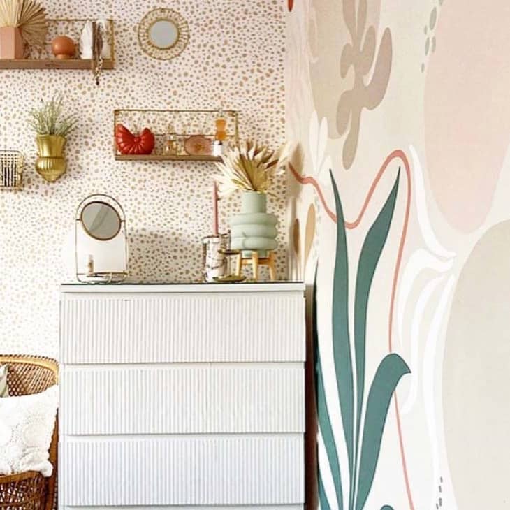 Corner of room with dresser and murals on wall