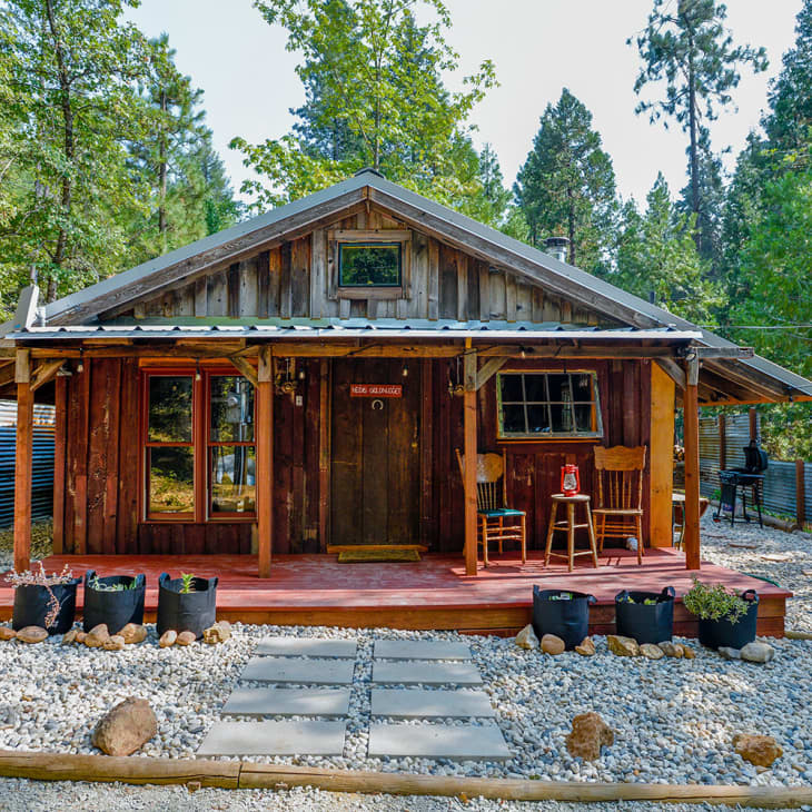 Rustic tiny house has a spacious interior and a balcony up top