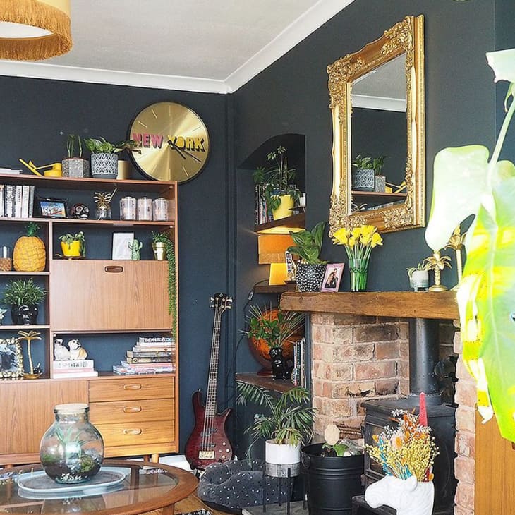 Living room with charcoal gray walls and gold and yellow accents throughout
