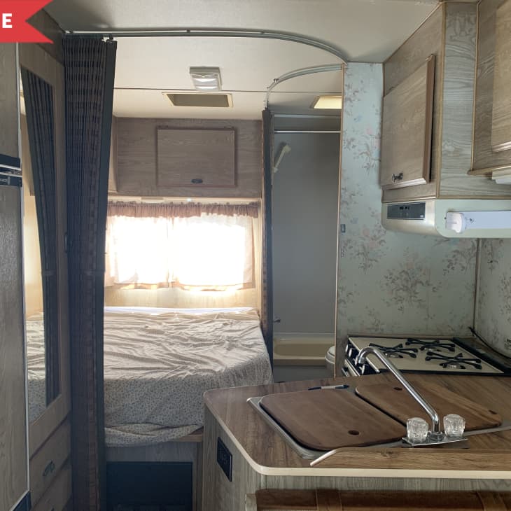 Before: Small kitchen area with wallpaper in RV