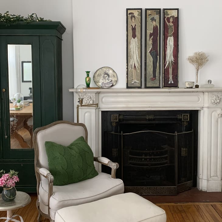 Marble fireplace, green wardrobe, and tan armchair