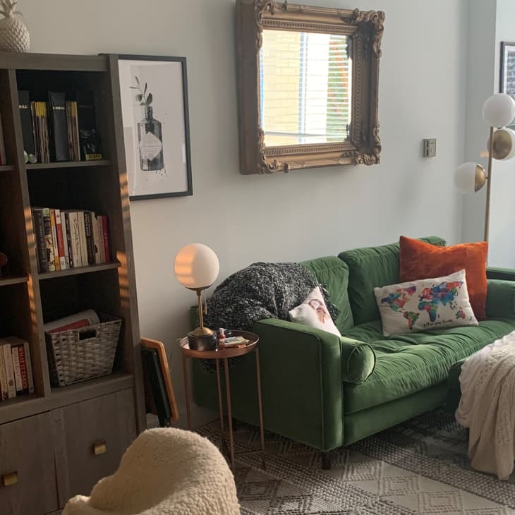 Living room with large bookshelf and green sofa