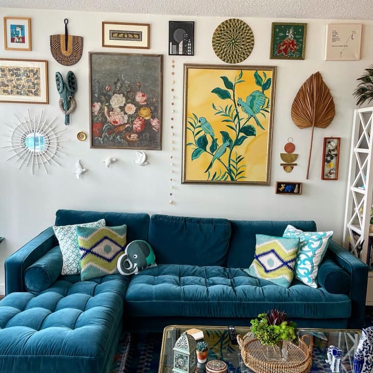 Living room with teal sofa and eclectic gallery wall
