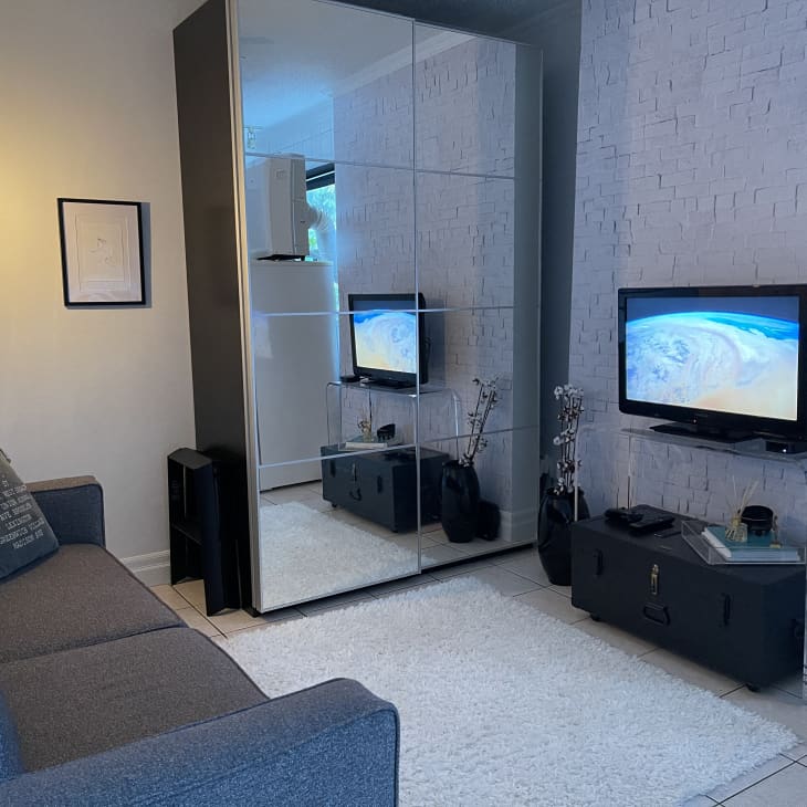 Living room with clear acrylic console table and gray sofa
