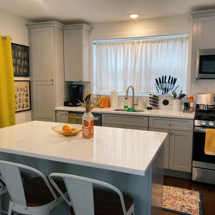Kitchen with gray cabinets and yellow/orange accents