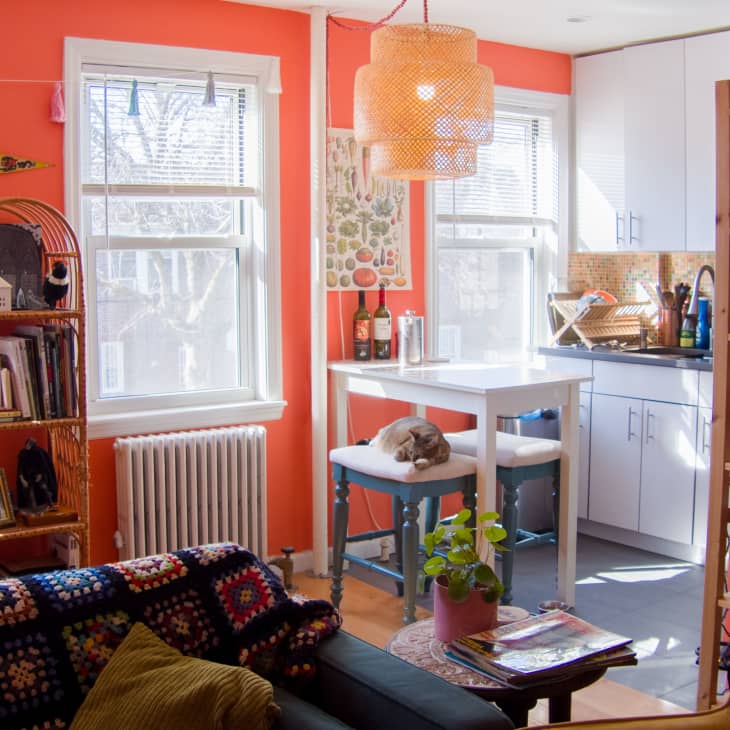 Orange living room leading into kitchen