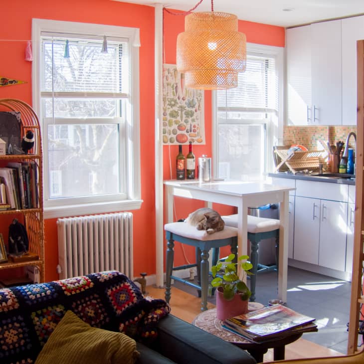 Orange living room leading into kitchen