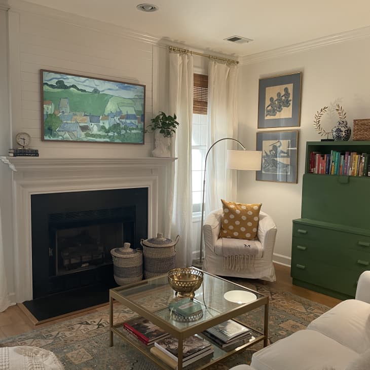 Living room with blue rug and white furniture