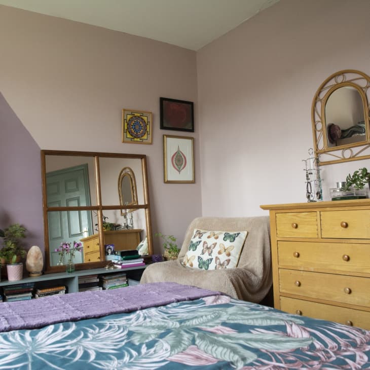 Purple bedroom with wooden dresser
