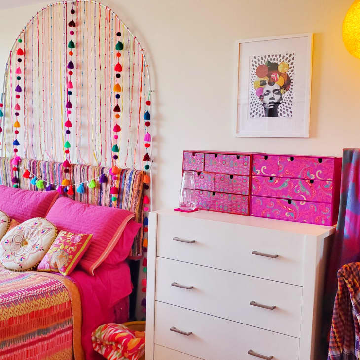 Bedroom with pink bed and storage