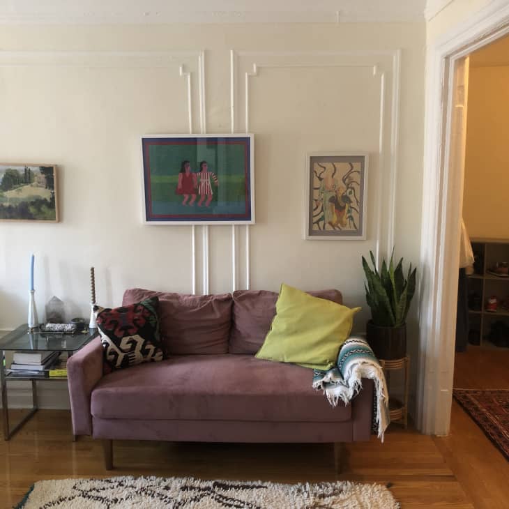 Purple sofa under art