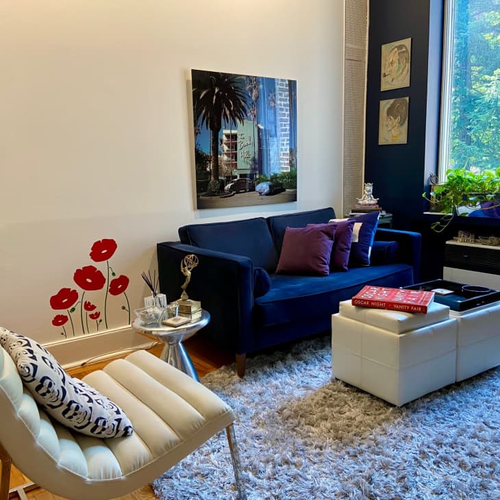A living room with a white chair and blue sofa