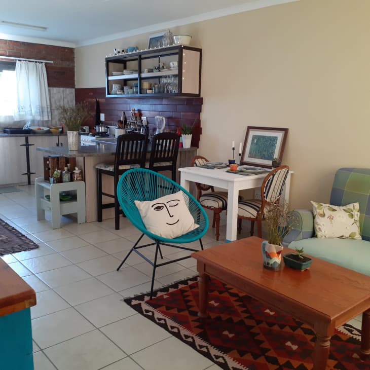 A living room with tiled floors and blue furniture