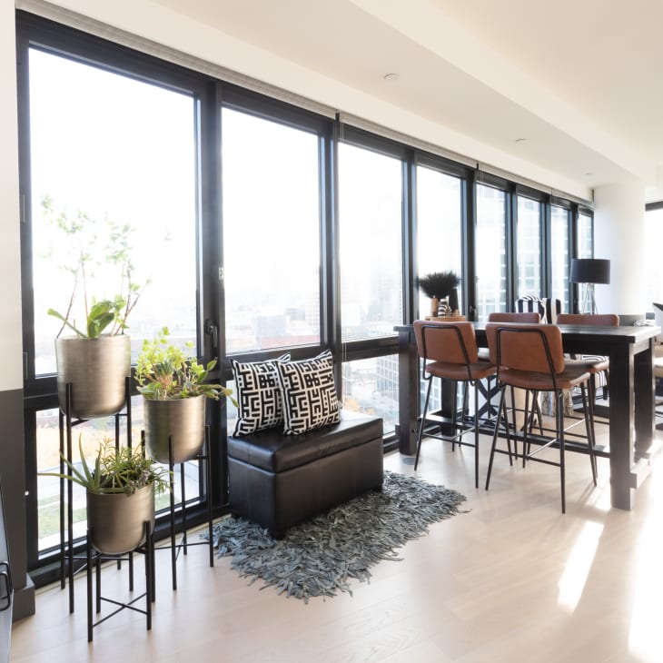 Living space, modern apartment with large windows, lots of black and white accents