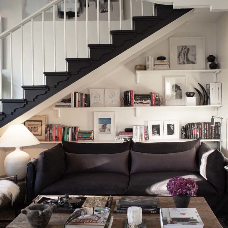 Apartment with white walls, black and brown accents - living room