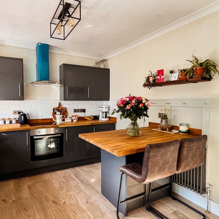 white kitchen with wood countertops and island