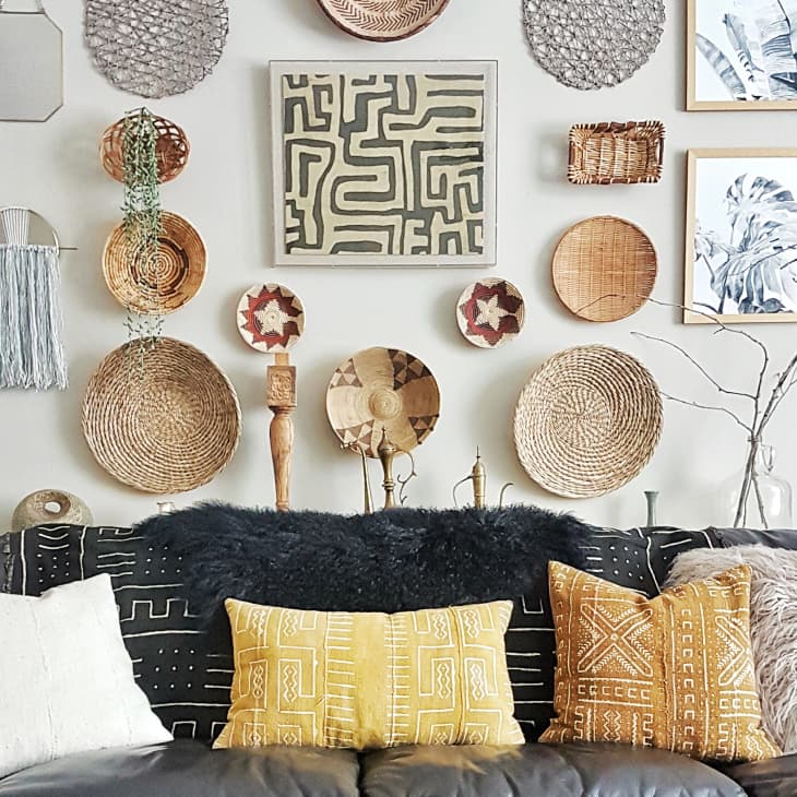 A wall decorated with hanging basket, among other objects