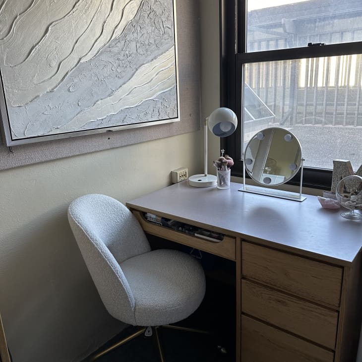 desk, small vanity mirror, orb desk lamp, M, makeup brushes, white soft rolling desk chair, natural light