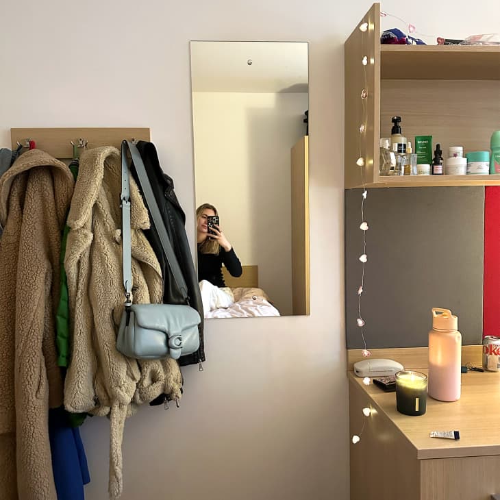 Student taking photo in dorm room.